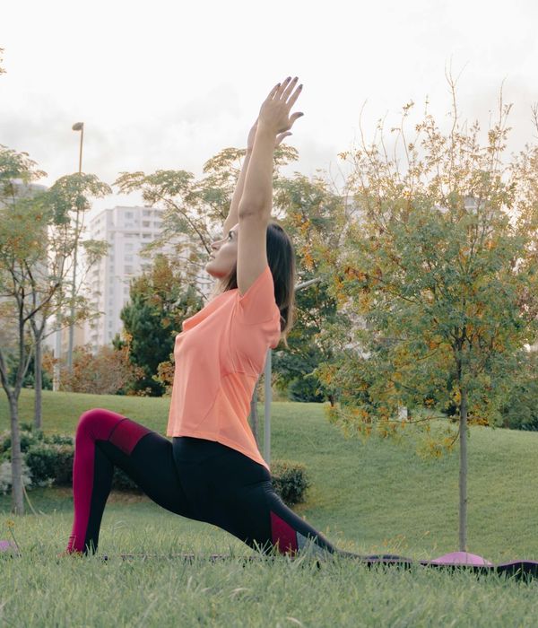Woman in a calm yoga pose, embodying natural rhythm.